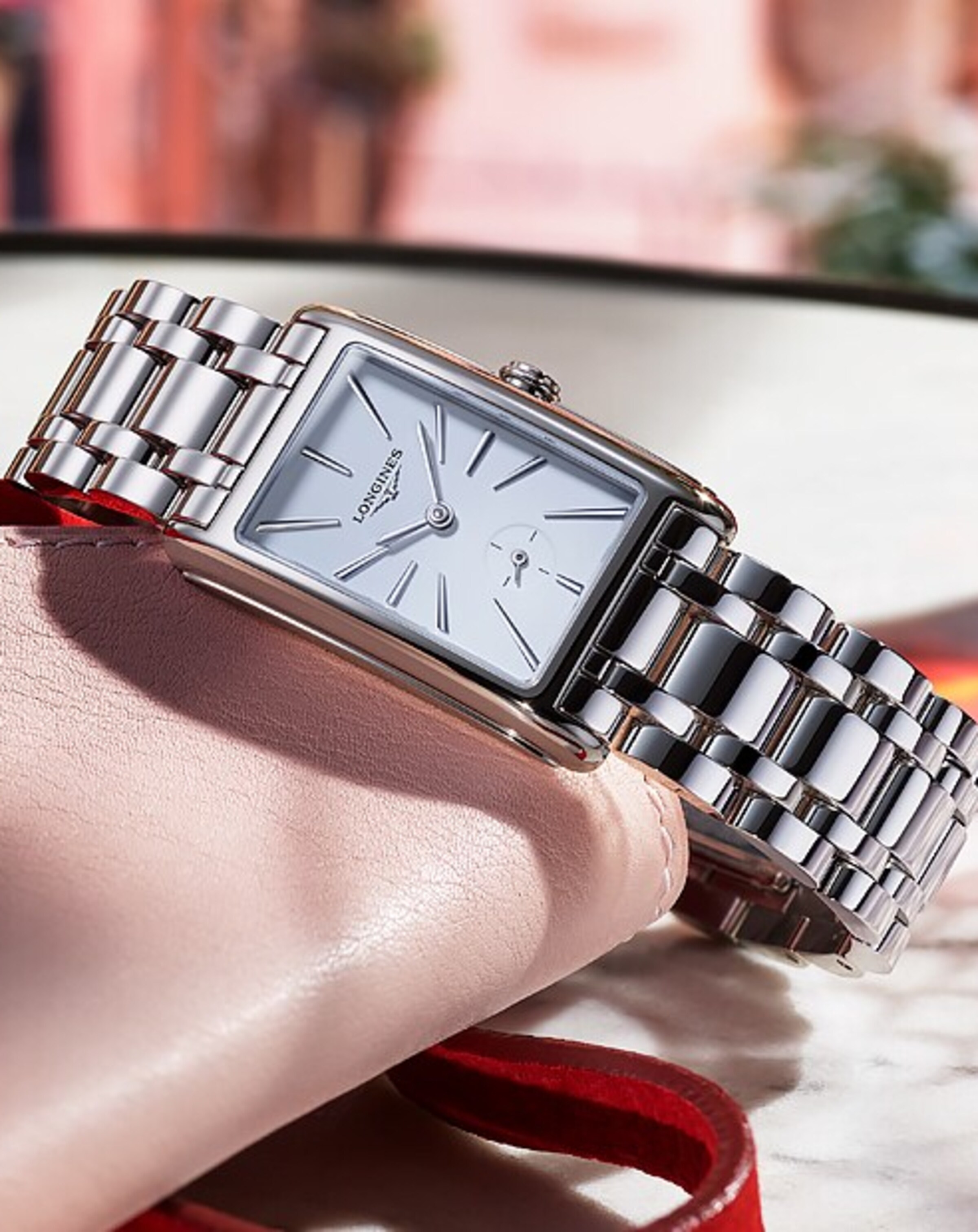 a Longines Dolcevita watch on a table