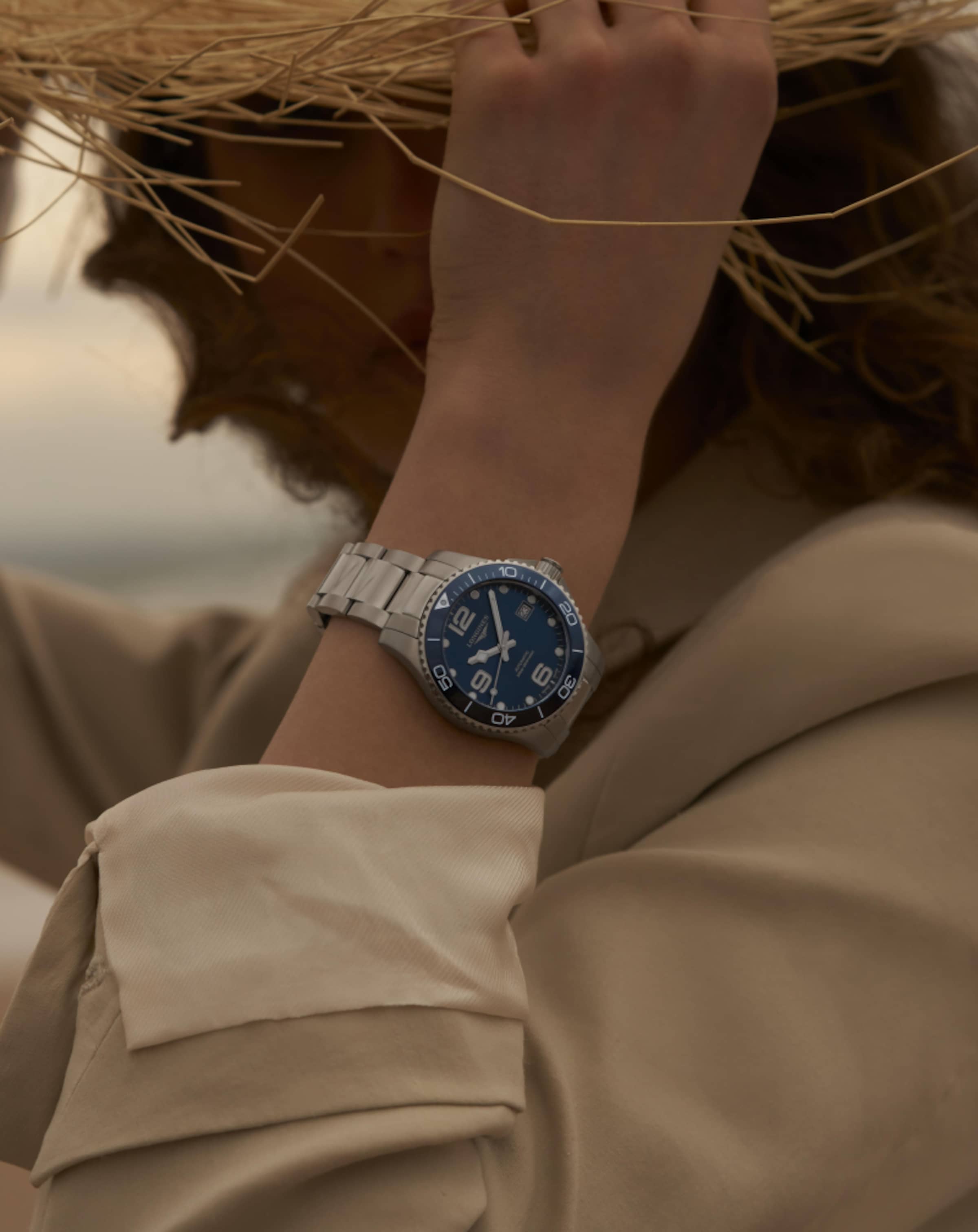 Cover a woman is wearing a Longines Hydroconquest watch