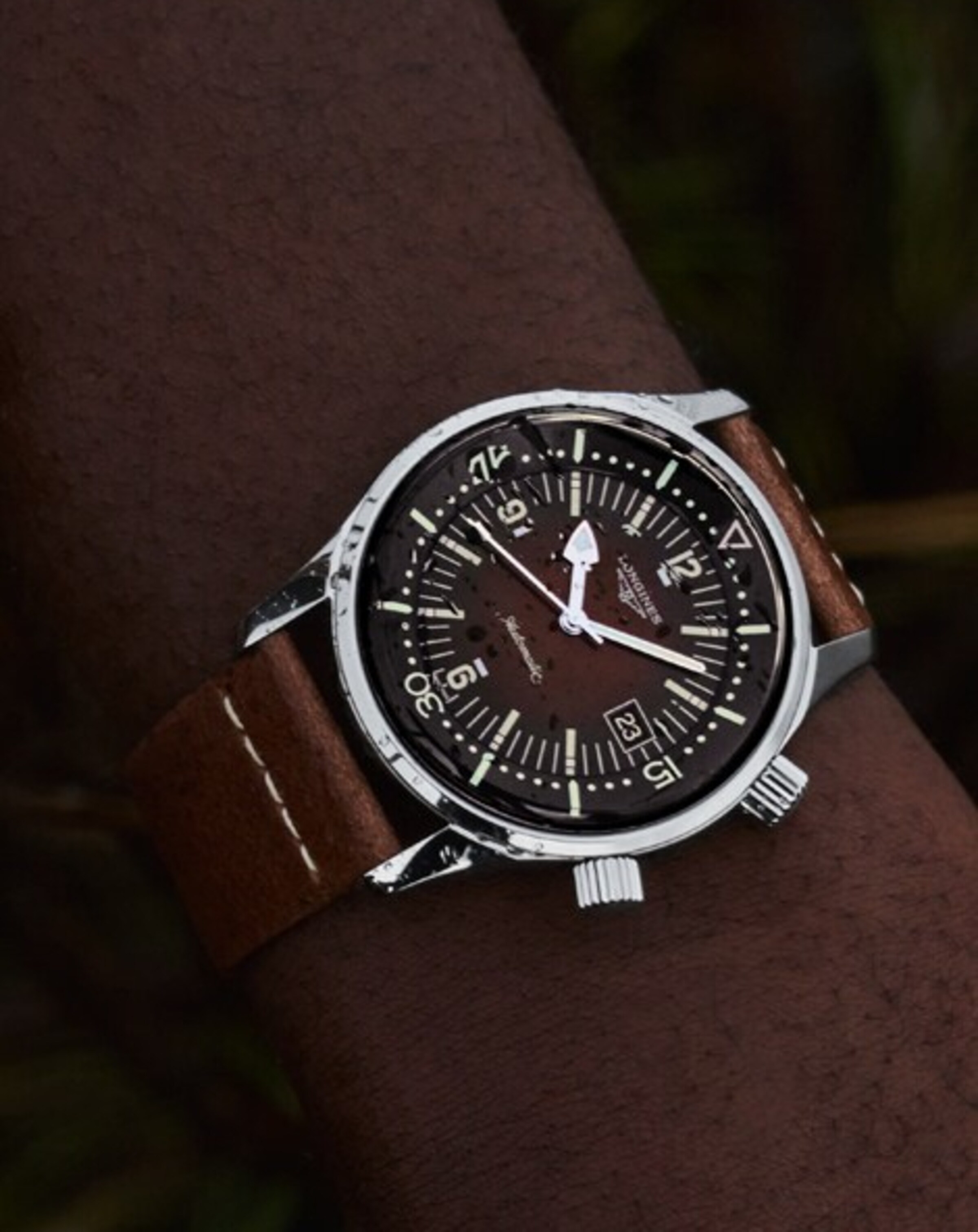 a Longines brown watch