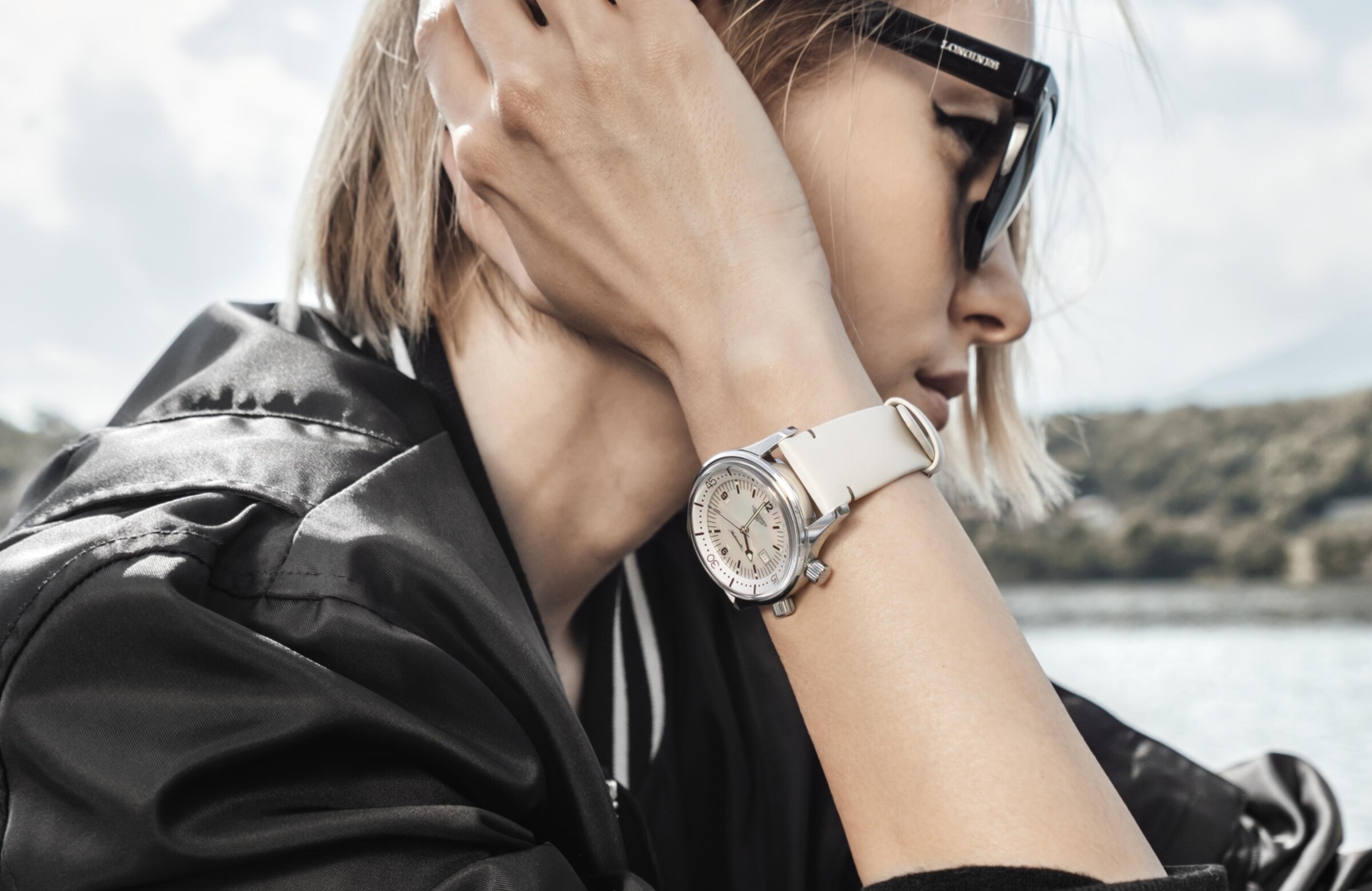 a woman is wearing a Longines watch