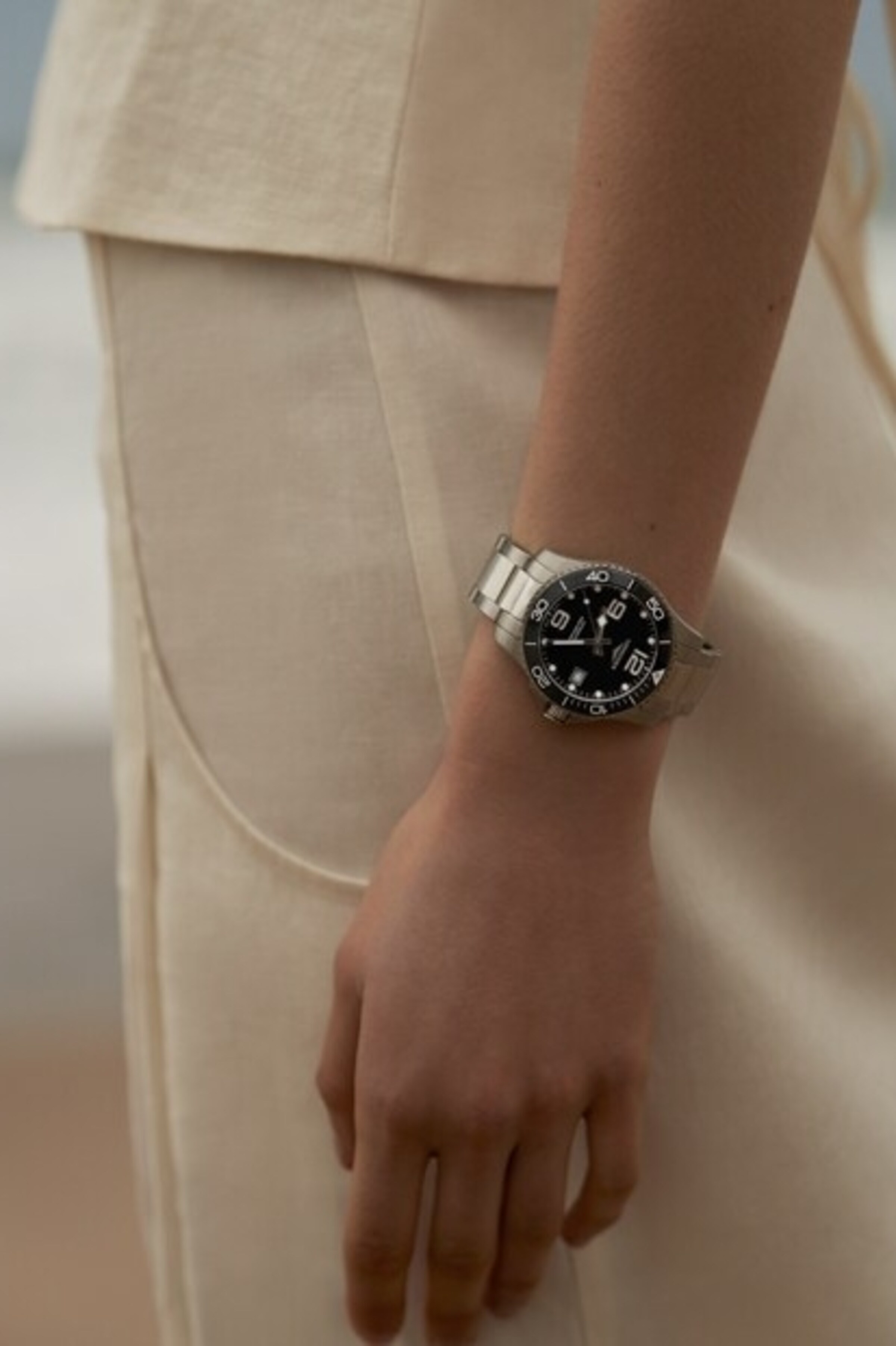 A woman is wearing a Longines Hydroconquest watch
