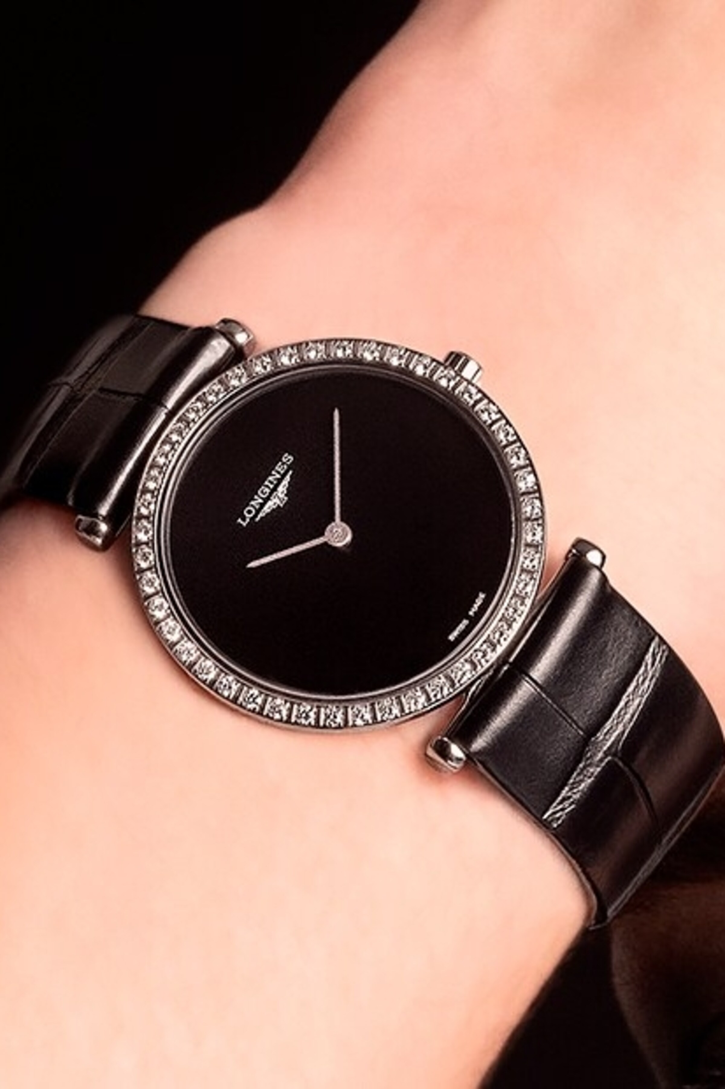 a Longines black watch with diamonds