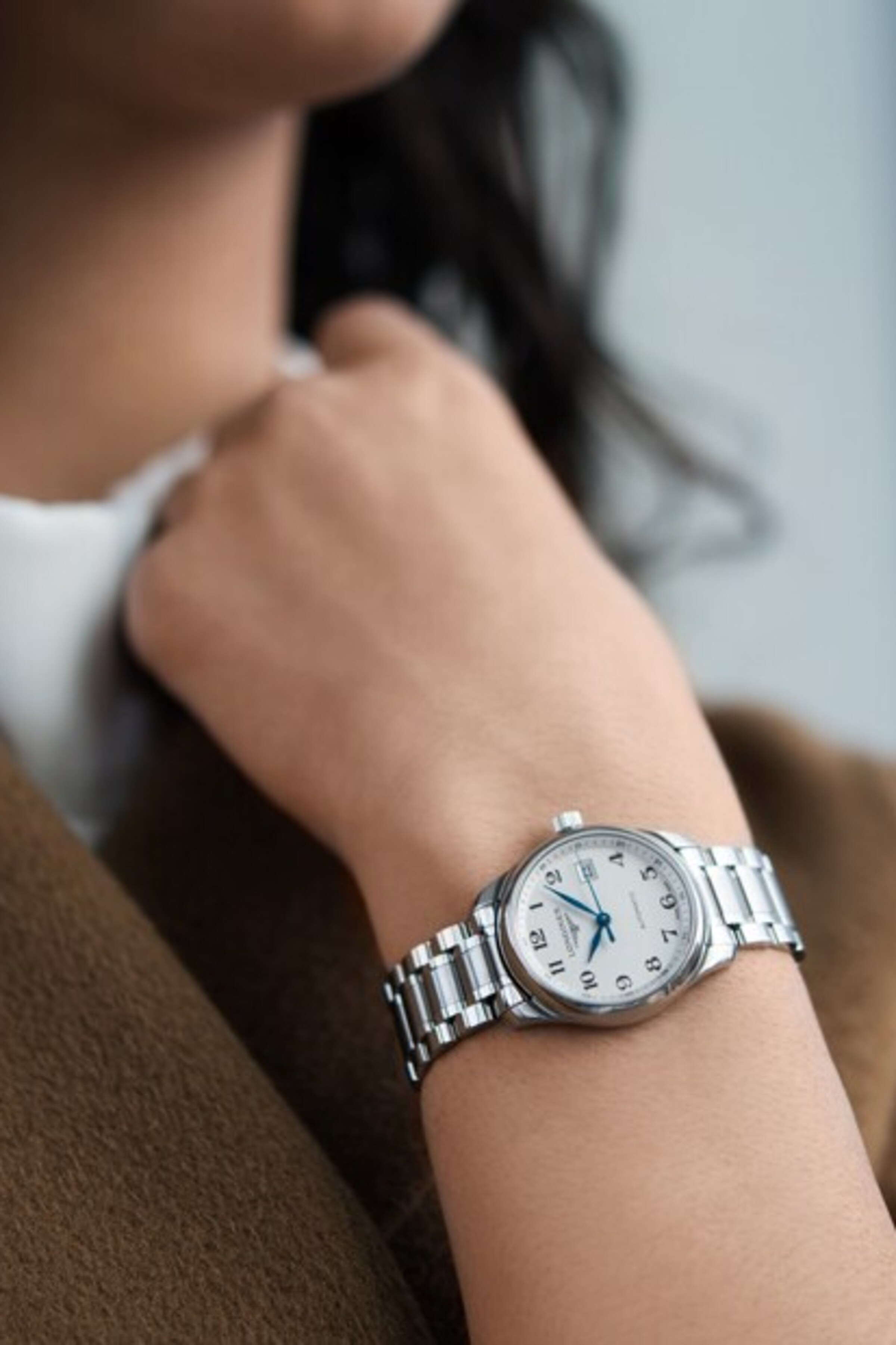 a Longines automatic watch on a female wrist