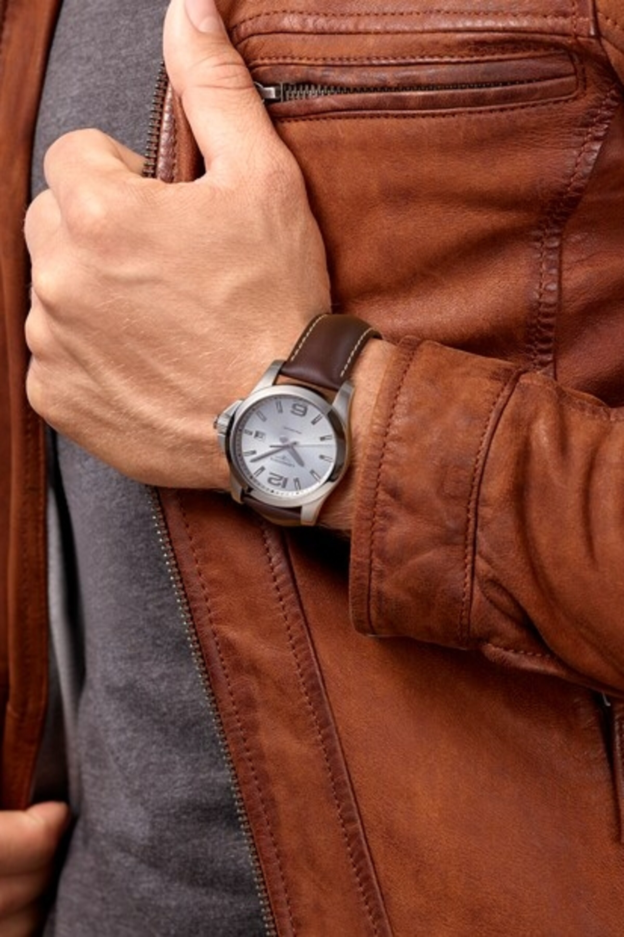 a Longines watch on a man wrist