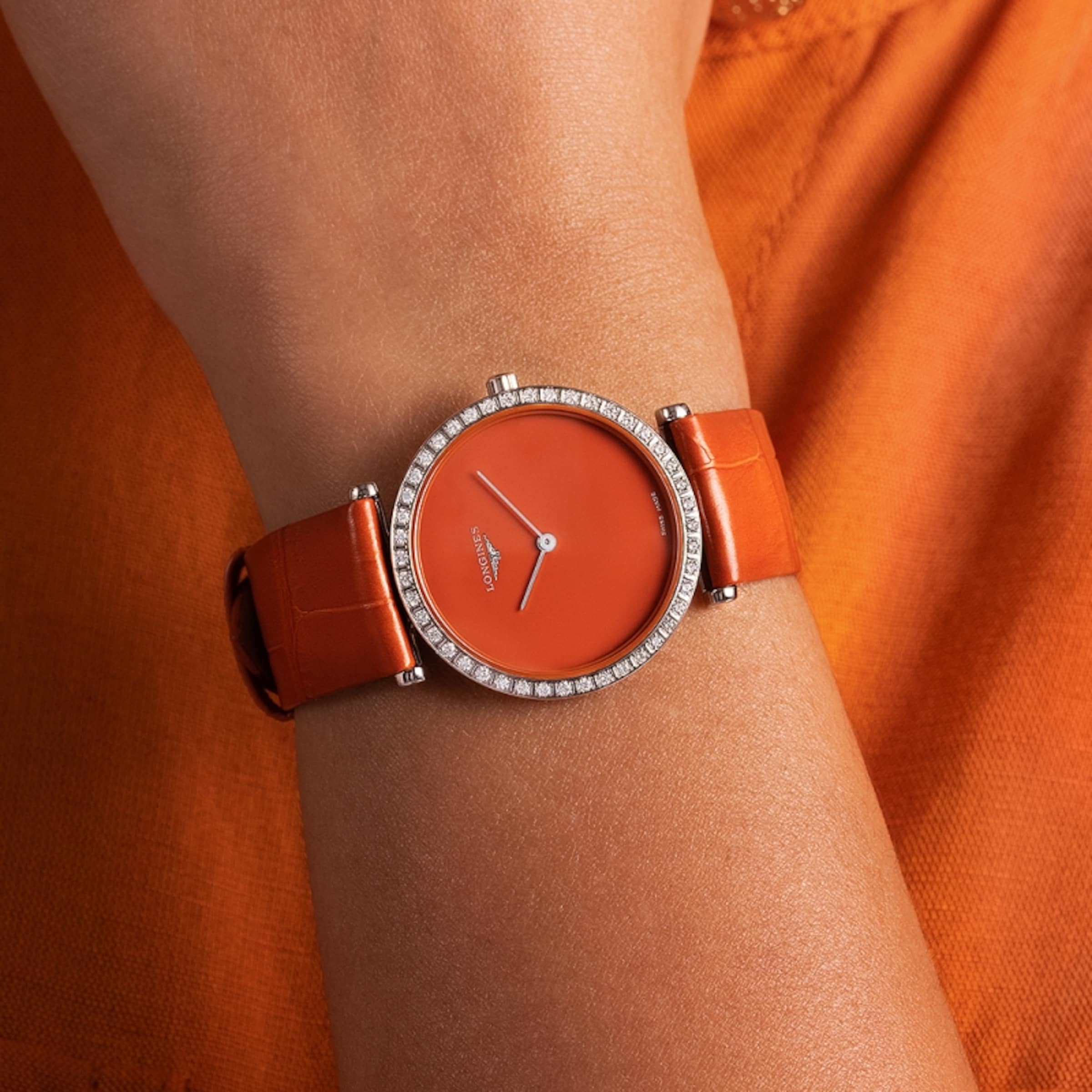 a woman is wearing La Grande Classique de Longines watch
