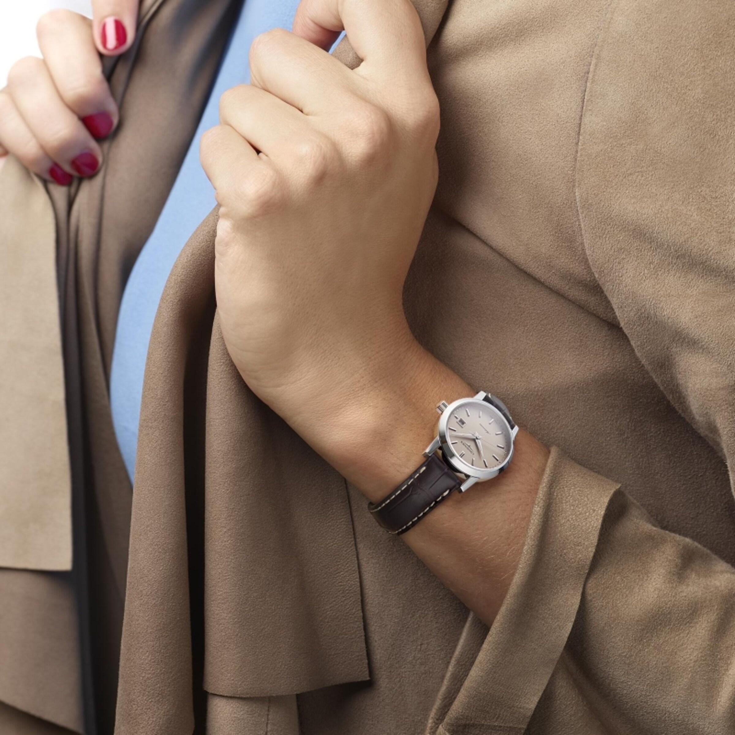 A woman is wearing the Longines 1832 watch